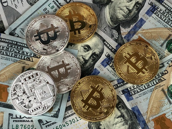 Stablecoin and Bitcoin coins on US dollar banknotes representing a USDC to SUI exchange